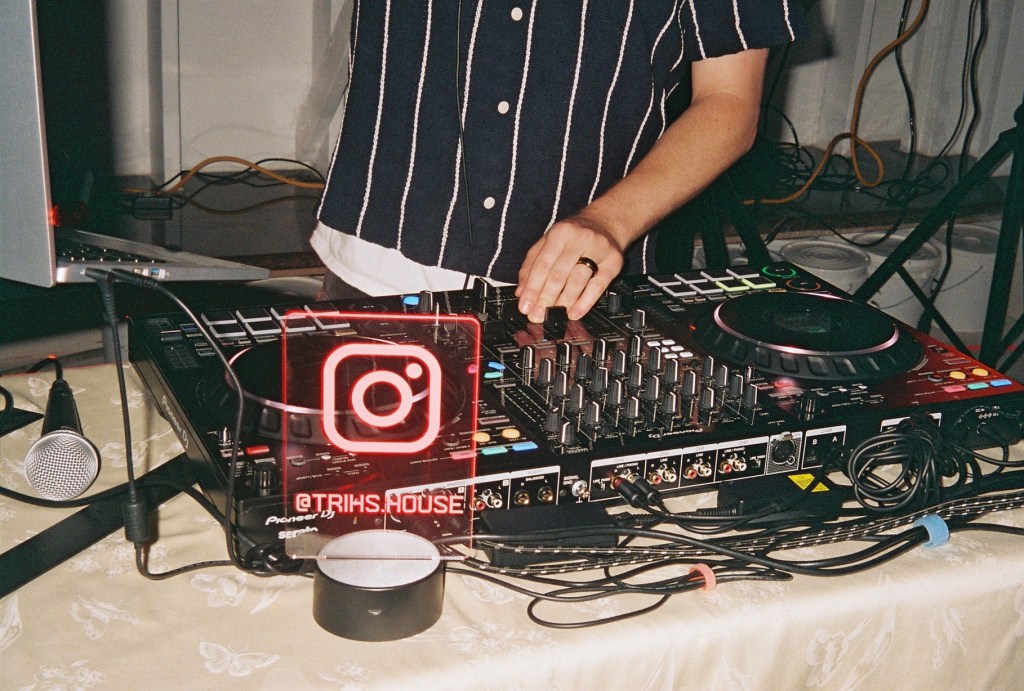 DJ deck with @trihs.house instagram logo lit up red